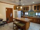 Spacious kitchen with island, modern appliances, and dining area