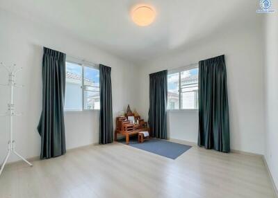 Minimalist bedroom with large windows and natural lighting