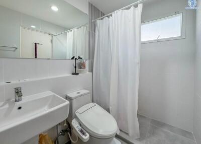 Modern bathroom with white fixtures and a shower area