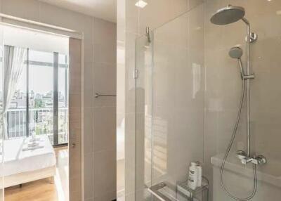 Modern bathroom with glass shower and city view