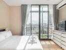 Modern bedroom with city view, bed, window, air conditioner, TV and drawers