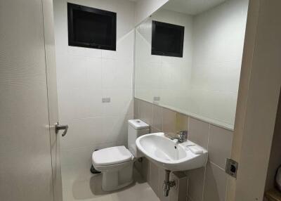 Modern bathroom with white fixtures and large mirror