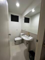 Modern bathroom with white fixtures and large mirror