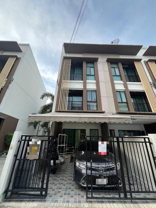 Three-story townhouse with gated driveway