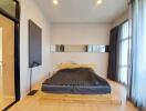 Modern bedroom with wooden bedframe and large windows