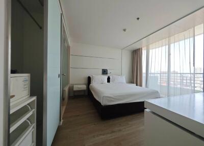 Modern bedroom with large windows and balcony view