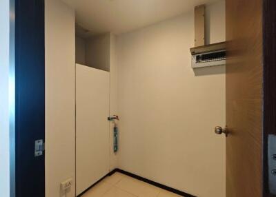 Simple utility room with white tiles and an air vent system