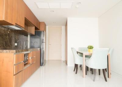 Modern kitchen and dining area with wooden cabinets and a dining table