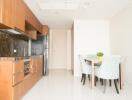 Modern kitchen and dining area with wooden cabinets and a dining table