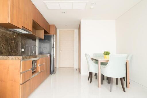 Modern kitchen and dining area with wooden cabinets and a dining table