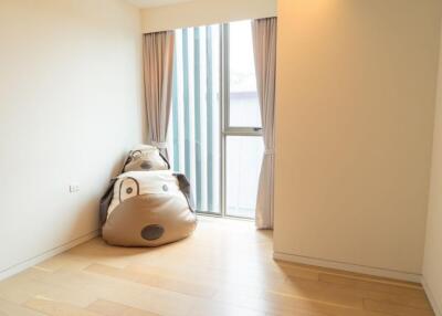 Empty bedroom with large window and bean bag chairs