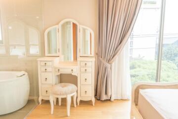 Elegant bedroom with dressing table and window view