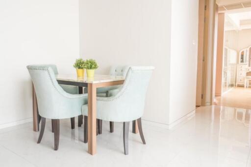 Small dining area with light blue chairs and a table with green plants