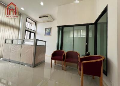 Well-lit office space with glass dividers and seating area