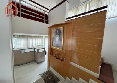 Modern staircase area with wooden paneling and artwork