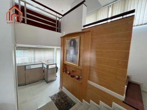 Modern staircase area with wooden paneling and artwork