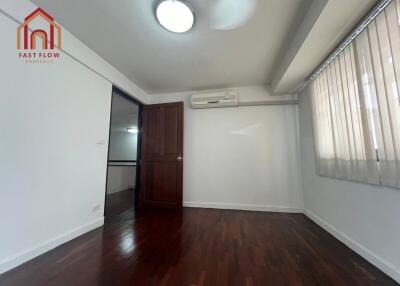 Unfurnished bedroom with wooden flooring and air conditioning