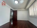 Unfurnished bedroom with wooden flooring and air conditioning