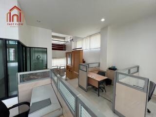 Modern office space with several cubicles and desks