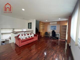 Spacious living area with modern wooden flooring and ample natural light