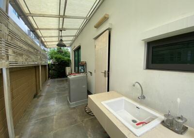 Outdoor utility area with sink and washing machine