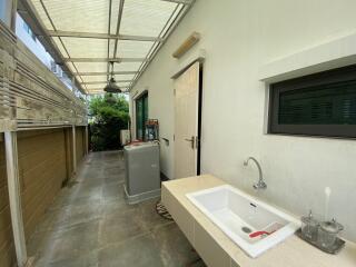 Outdoor utility area with sink and washing machine