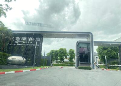 Entrance to the Setthasiri residential estate with gate and security checkpoint