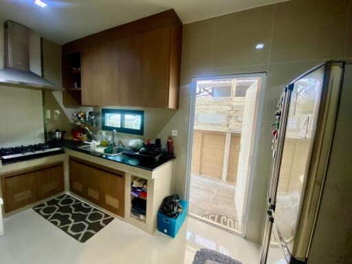 Modern kitchen with wooden cabinets and stainless steel appliances