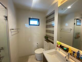 Modern bathroom with sink, mirror, toilet, and shower