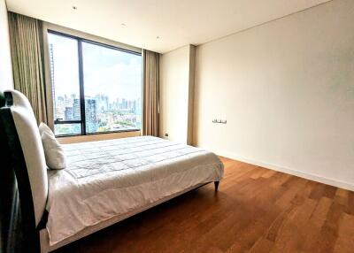 Spacious bedroom with large window and city view