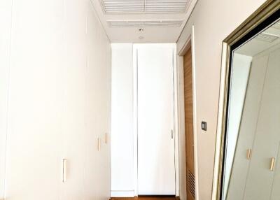 Hallway with wooden flooring and a large mirror