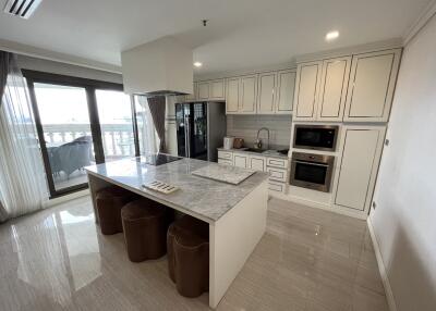 Modern kitchen with white cabinetry and marble island
