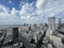 Aerial view of a city with high-rise buildings and a cloudy sky