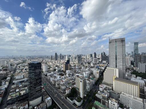 Aerial view of a city with high-rise buildings and a cloudy sky