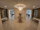 Spacious entrance hallway with chandelier and decorative table