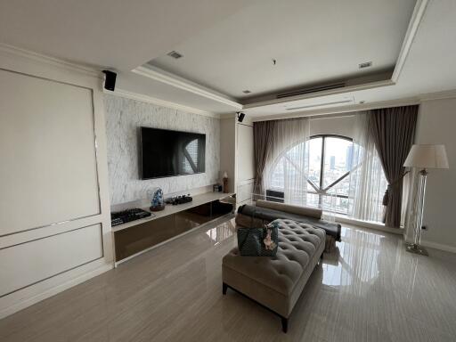 Modern living room with large window and city view.