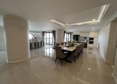 Spacious and modern dining area with elegant furnishings and a bar