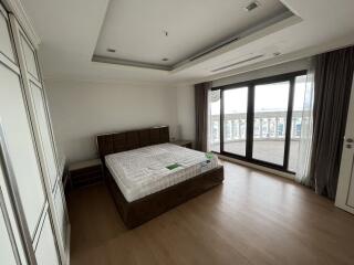 Spacious bedroom with large windows and balcony access