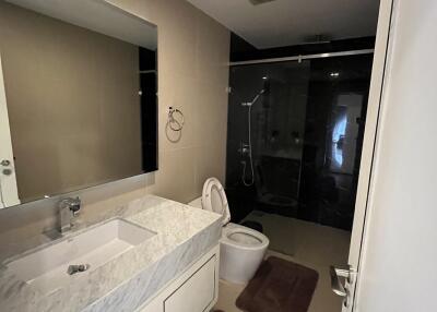 Modern bathroom with glass shower and marble countertop