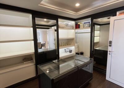 Well-organized closet with built-in shelves and mirrored doors