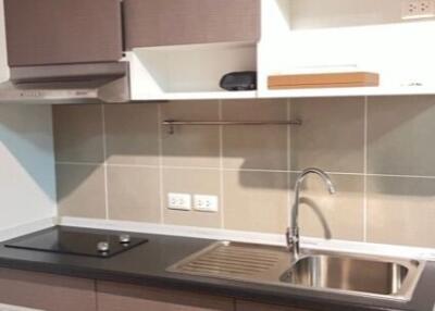 Modern kitchen with brown cabinets and stainless steel sink