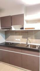 Modern kitchen with brown cabinets and stainless steel sink