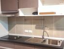 Modern kitchen with brown cabinets and stainless steel sink