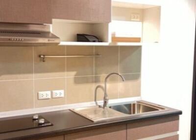 Modern kitchen with brown cabinets and stainless steel sink