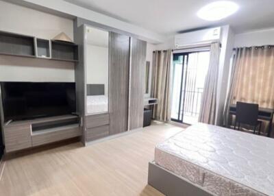 Modern bedroom with large wardrobe and balcony access