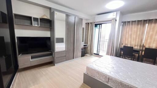 Modern bedroom with large wardrobe and balcony access