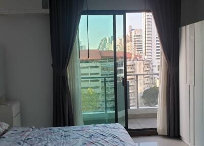 Modern bedroom with large window and city view