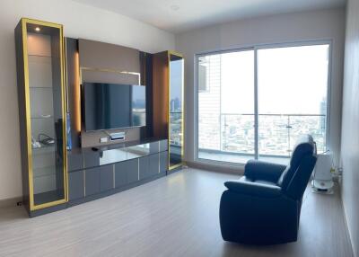 Modern living room with a large window and entertainment center