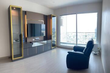 Modern living room with a large window and entertainment center