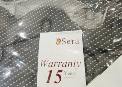 Close-up of a mattress with a 15-year warranty card